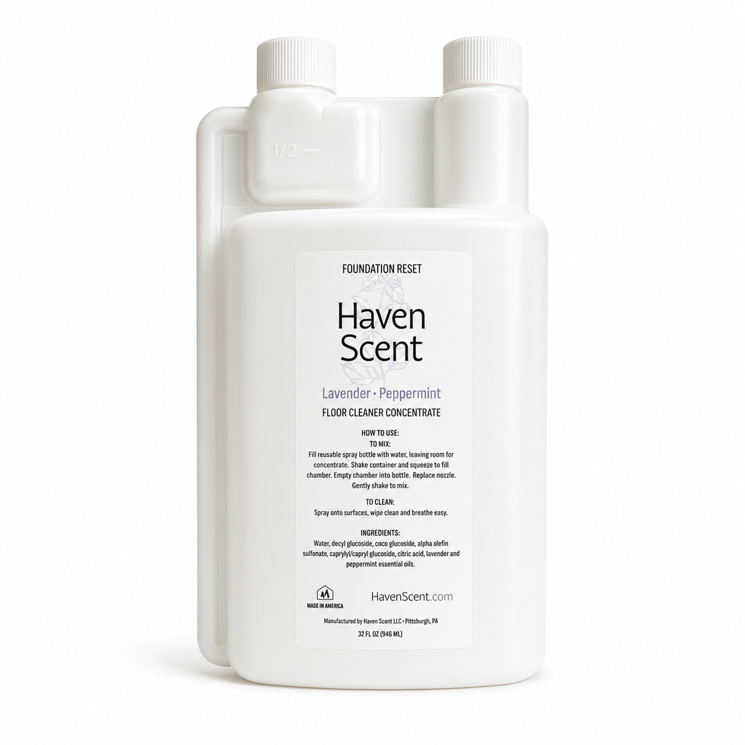 A white plastic bottle of Haven Scent Lavender + Peppermint Floor Cleaner Concentrate, featuring a clean white label and two ribbed white caps, set against a plain white background.