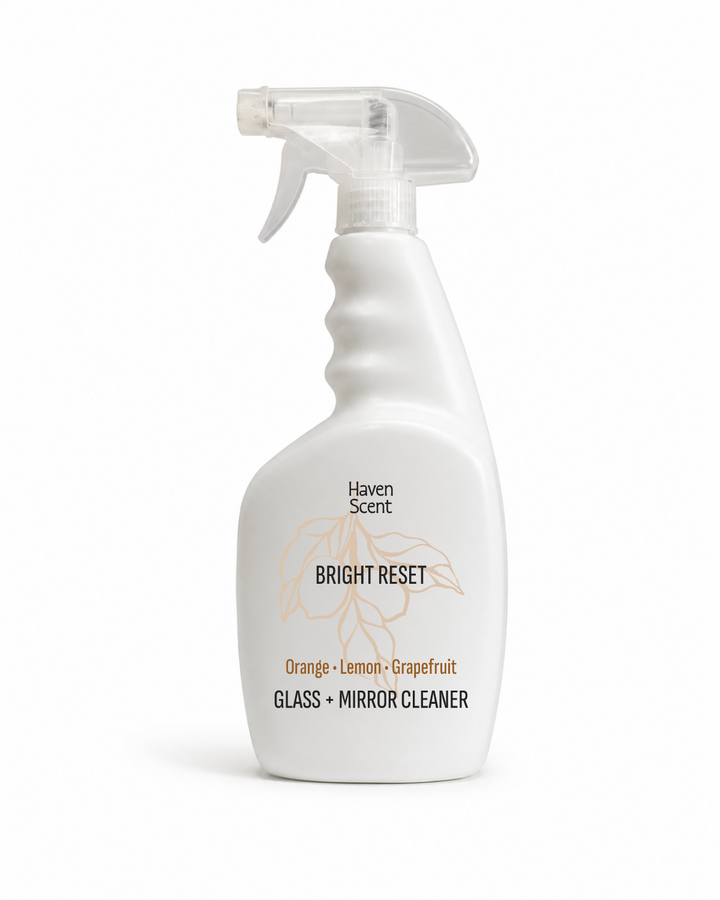 A white spray bottle of Haven Scent Bright Reset glass and mirror cleaner, featuring a clear trigger spray top and a label with orange and black text on a white background.